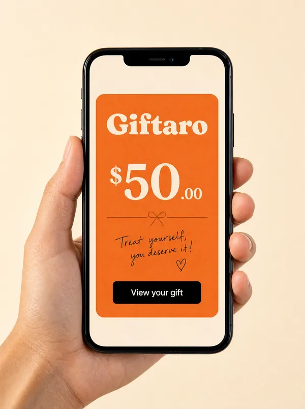 A hand holding a phone showing a Giftaro eGift email with a $50.00 card and a View your gift button